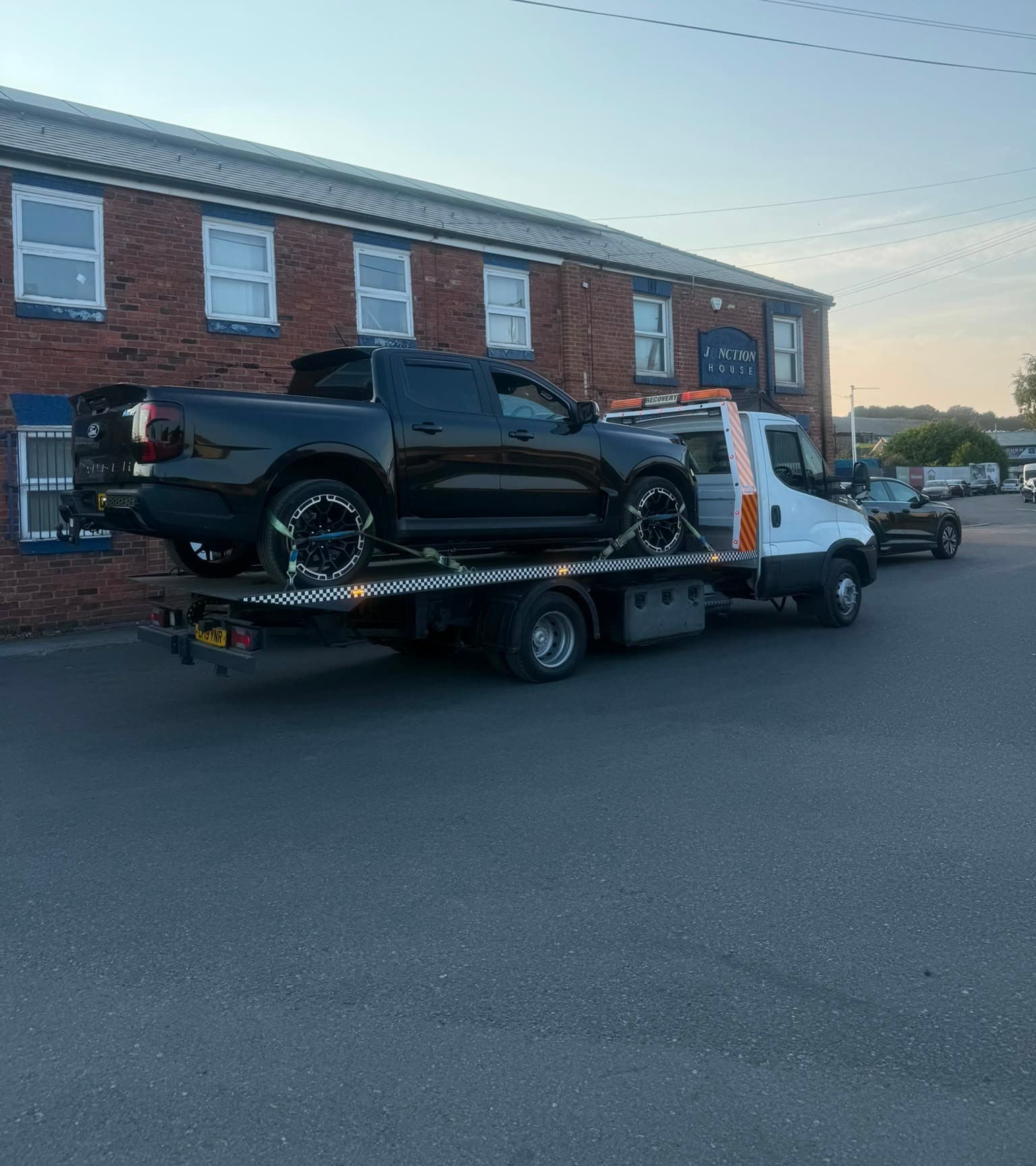 Glasgow Breakdown Recovery flatbed truck with a Ford Ranger at dusk